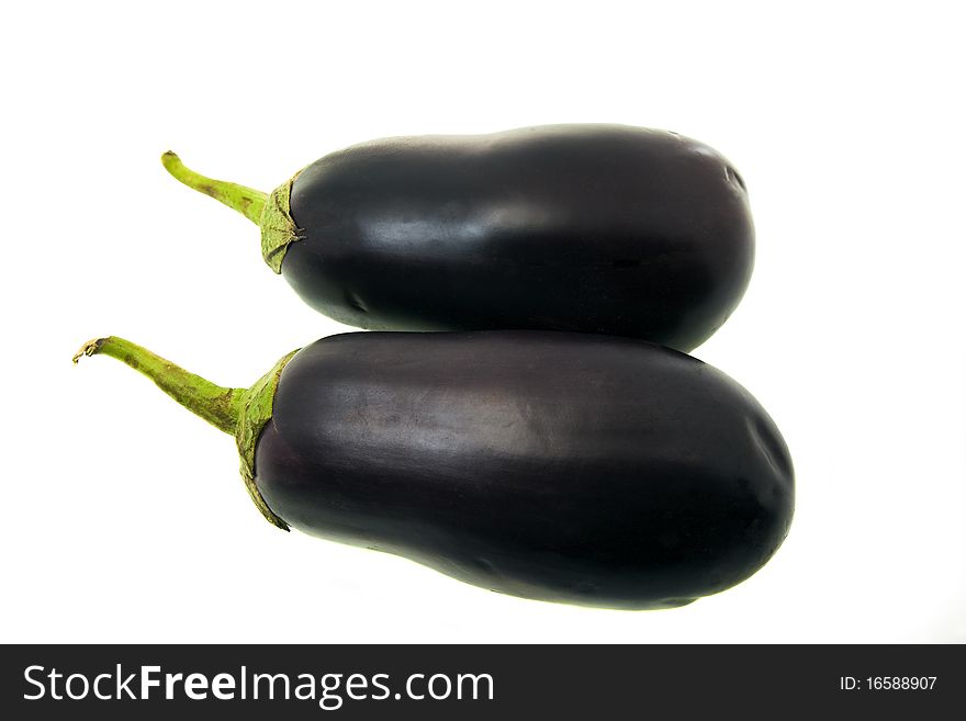 Two eggplants lying together on a white background
