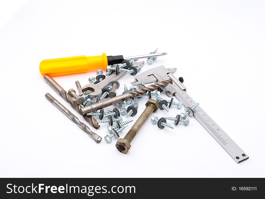 Building,metalworking instruments, and screws on white background
