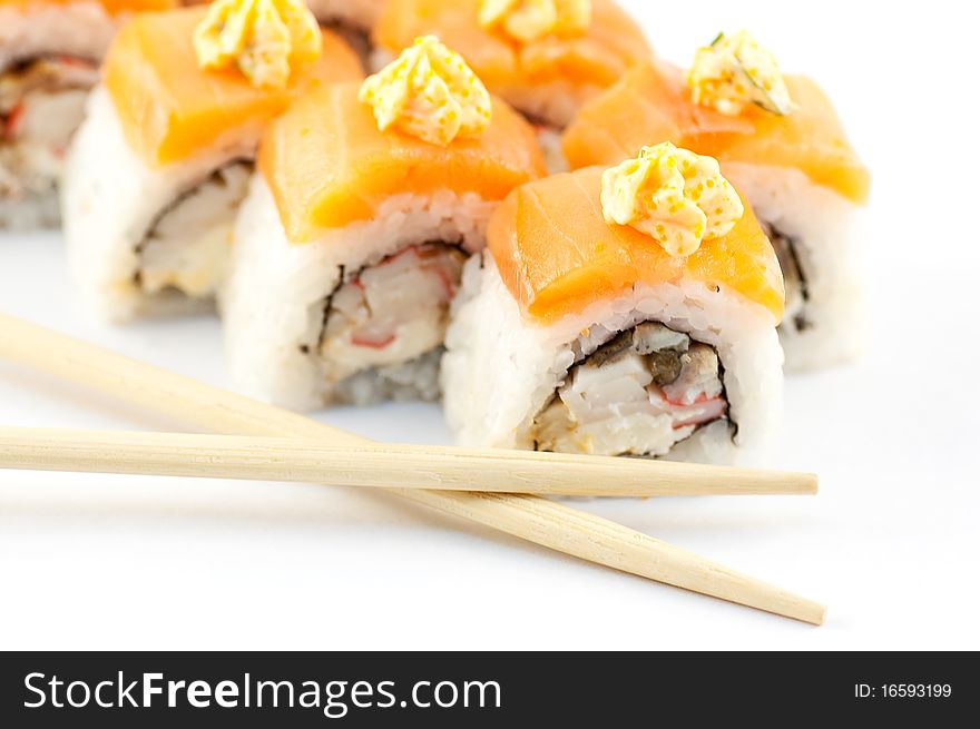 Sushi with sticks on a white background close up