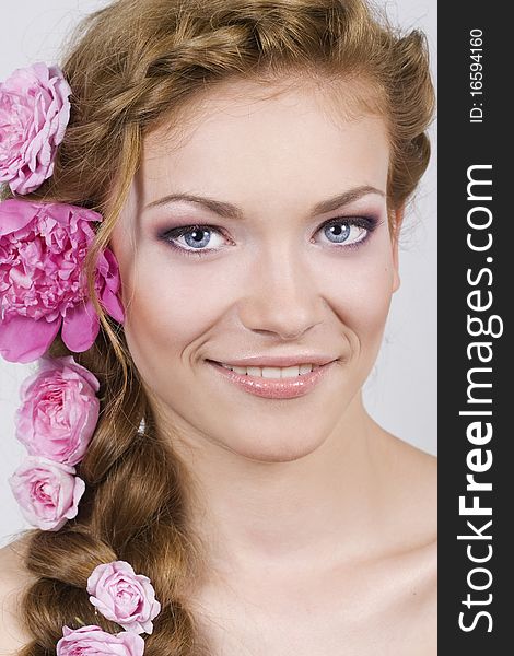 Portrait of young woman with with braids and flowers in hair. Portrait of young woman with with braids and flowers in hair