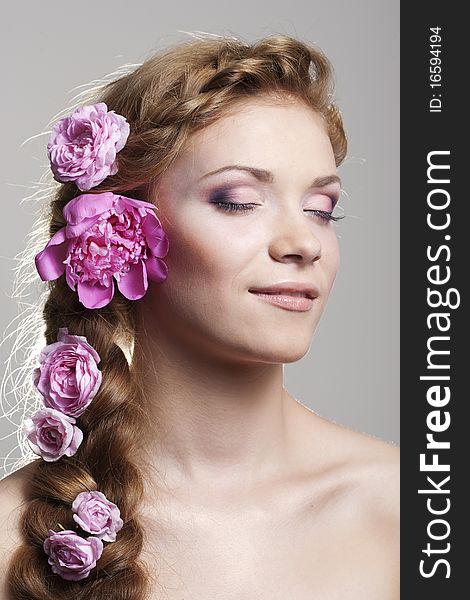 Portrait of young woman with with braids and flowers in hair. Portrait of young woman with with braids and flowers in hair