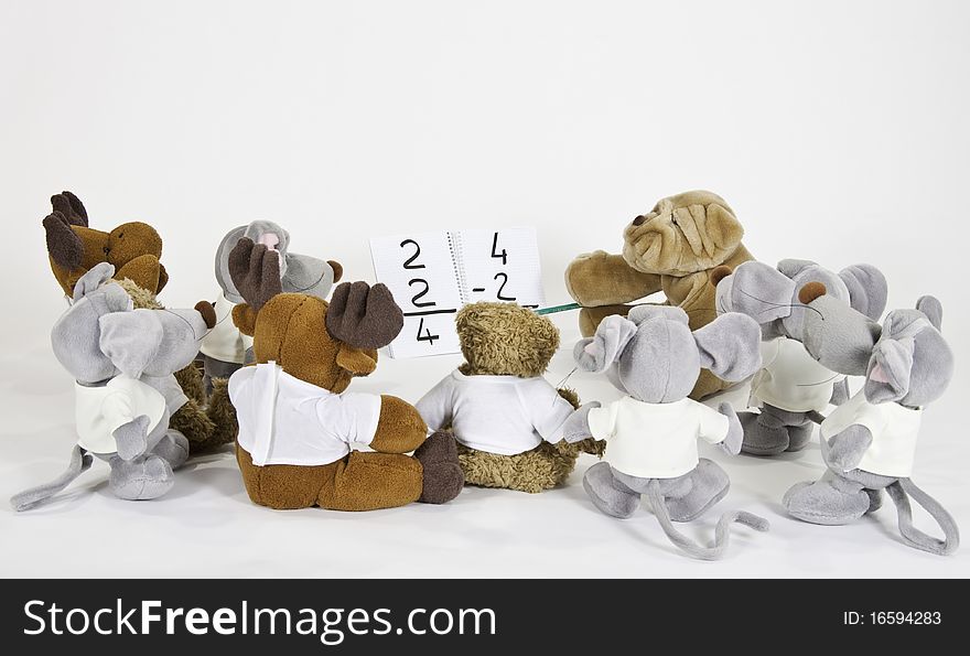 This image shows several stuffed animals in math class. This image shows several stuffed animals in math class