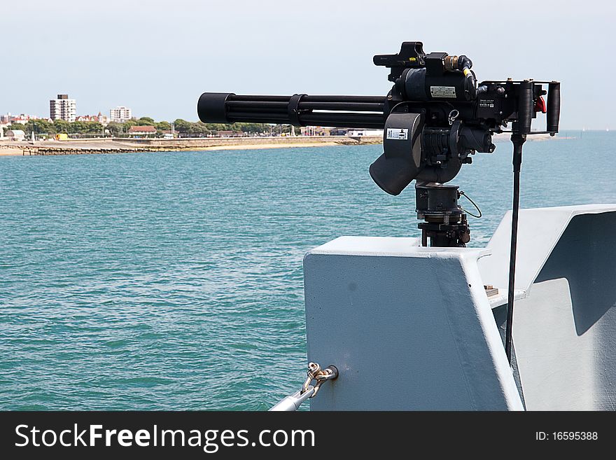 A Royal Navy Mini Gun mounted on the side of a Royal Naval Minehunter Class ship