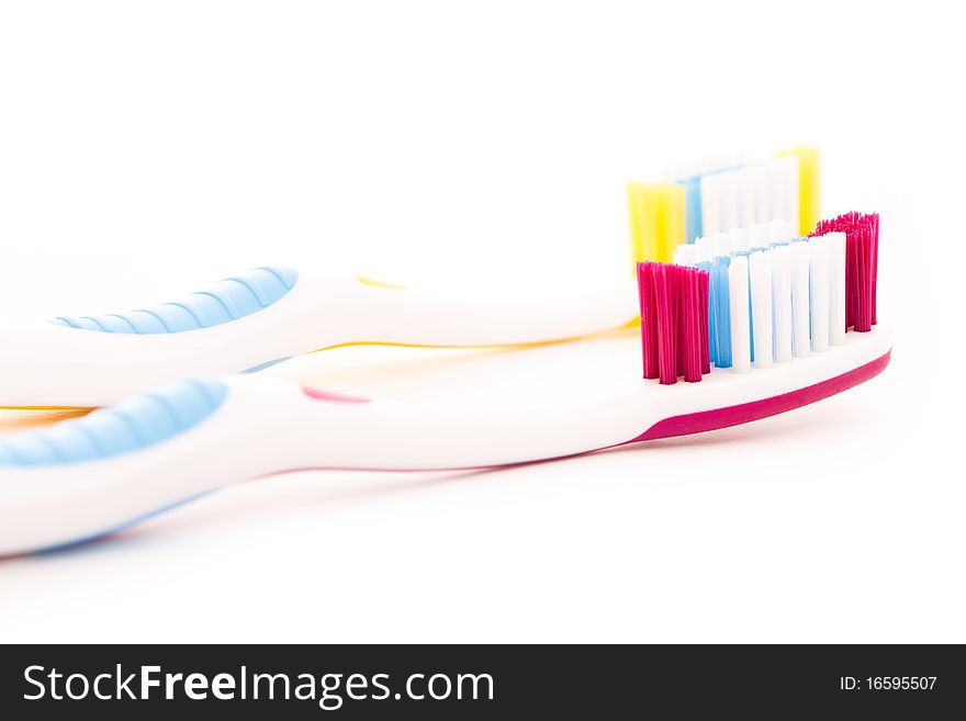 Red and yellow toothbrushes isolated on white