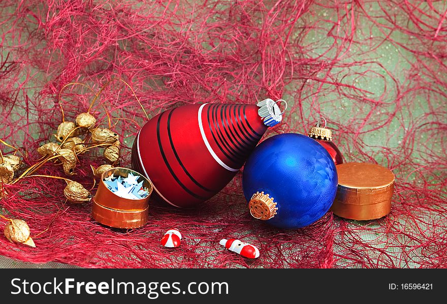 Christmas decorations with gift box on a red background. Christmas decorations with gift box on a red background.