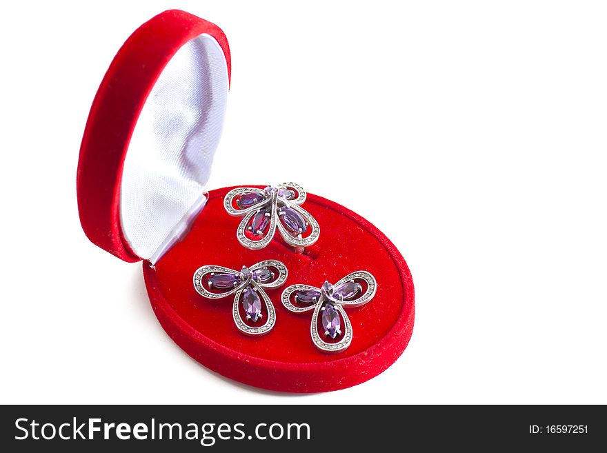 Closed gift box with ring and two earrings inside isolated over white