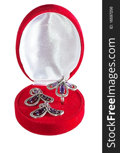 Closed gift box with ring and earrings inside isolated over white