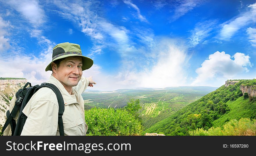 Brisk tourist shows the direction on a country road. Brisk tourist shows the direction on a country road