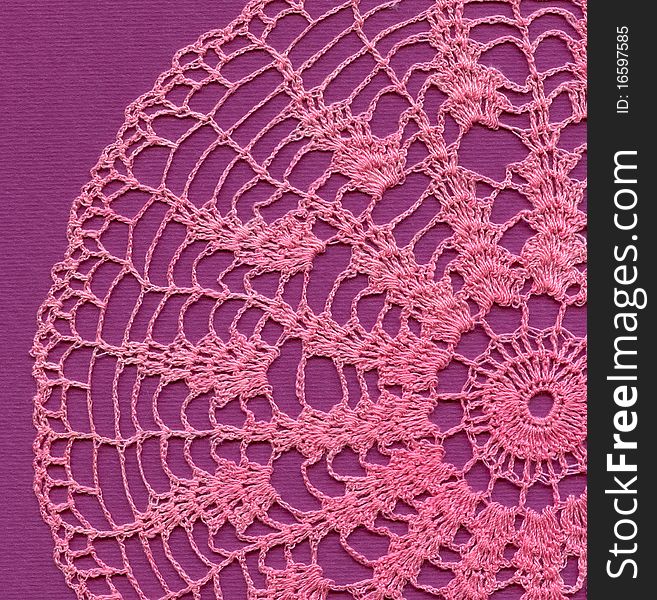 Pink knitted napkin and violet background