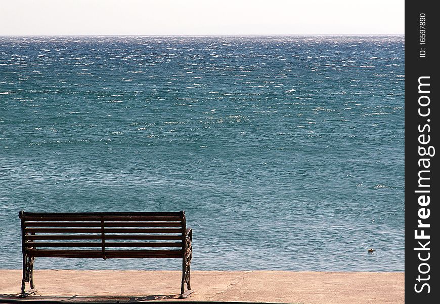 A bench on a promenade in Plakias, Crete, Greece. A bench on a promenade in Plakias, Crete, Greece.