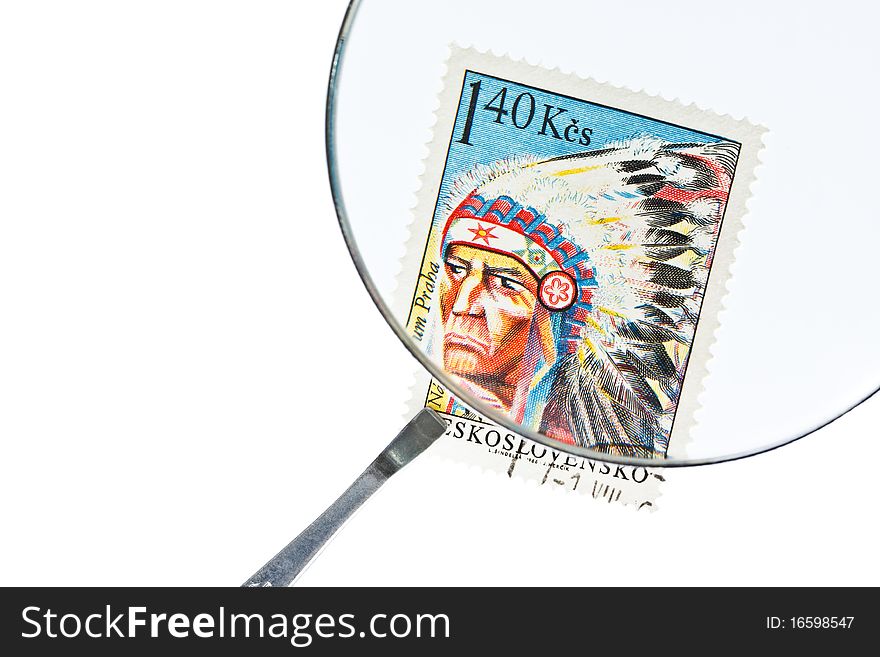 Postage stamp under magnifiying glass with tweezers. Postage stamp under magnifiying glass with tweezers