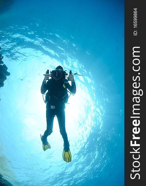 Female scuba diver with underwater video camera. Female scuba diver with underwater video camera