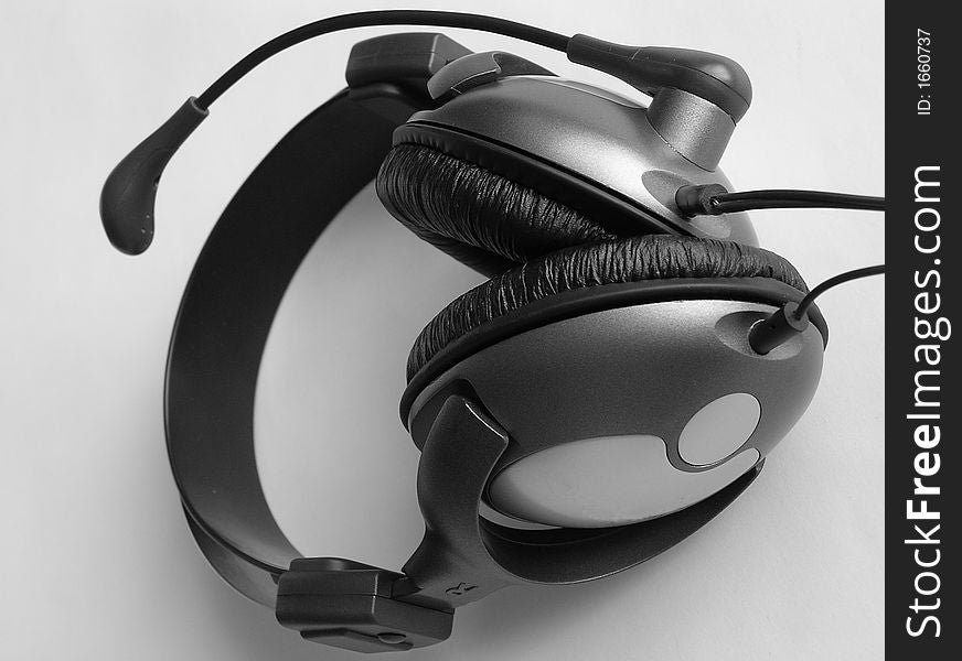 On a photo it is made in Ukraine headphones which are represented lay on a white background. A black-and-white photo. On a photo it is made in Ukraine headphones which are represented lay on a white background. A black-and-white photo