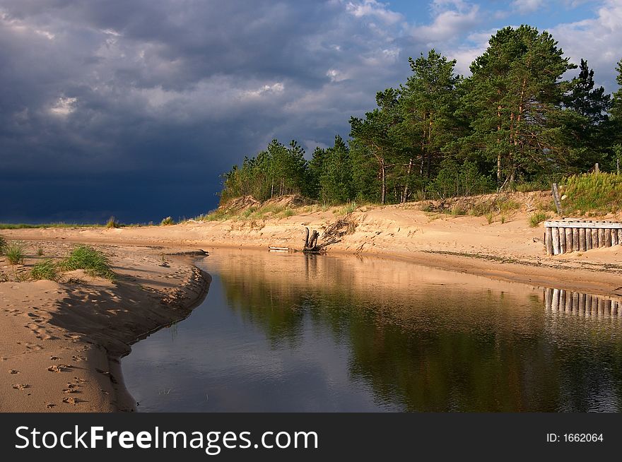 Seacoast, sun and dark clouds, river, forest