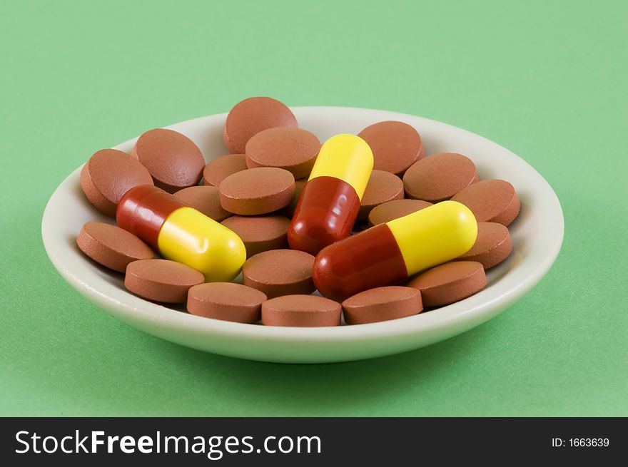 Three red and yellow pills, could be anything from vitamins to illegal drugs but actually cold and flu tablets!. Three red and yellow pills, could be anything from vitamins to illegal drugs but actually cold and flu tablets!