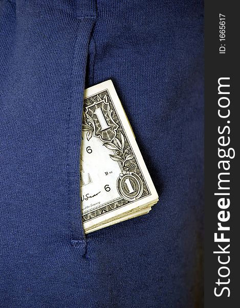 A few bank notes popping out of a pant pocket. A few bank notes popping out of a pant pocket