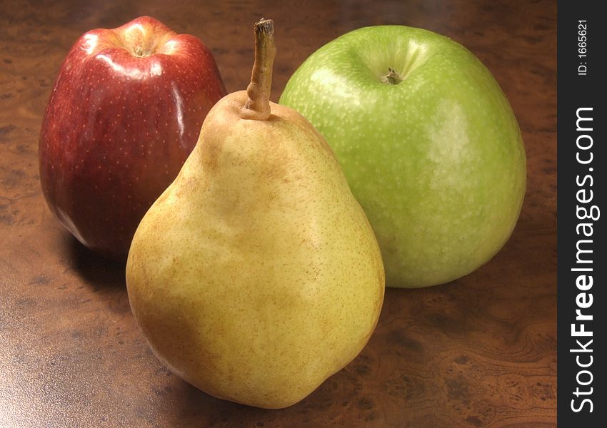 Greater, ripe two apples and pear on a table. Greater, ripe two apples and pear on a table.
