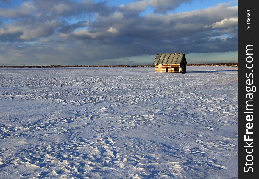 Winter lake with the flooded house on a background of the sky. Winter lake with the flooded house on a background of the sky.