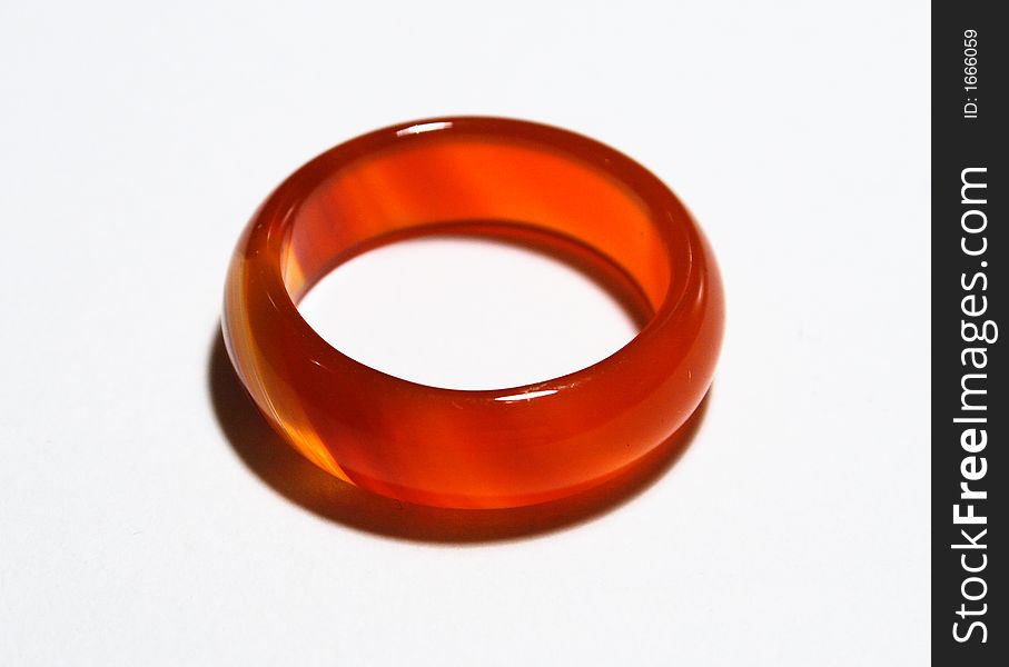 A delicate, amber ring on a plain white background