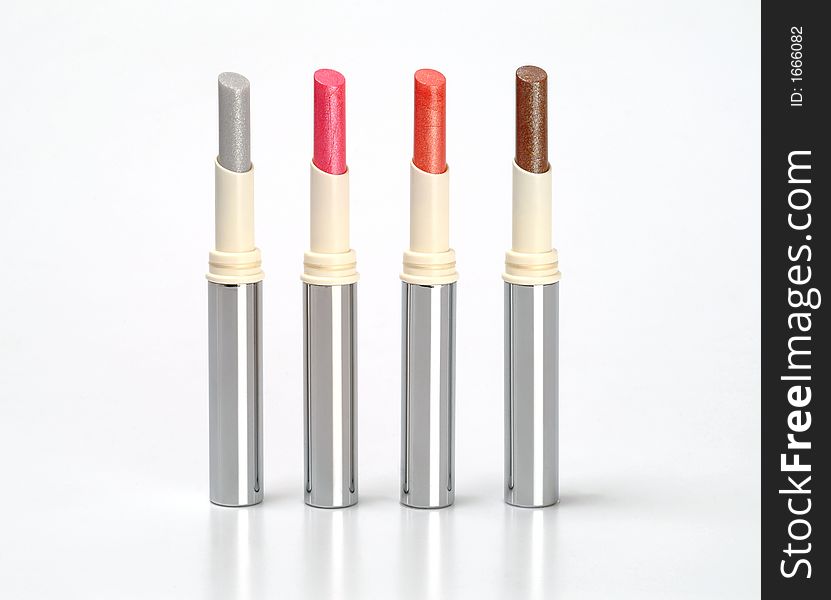 Group of multi-coloured lipsticks on a white background