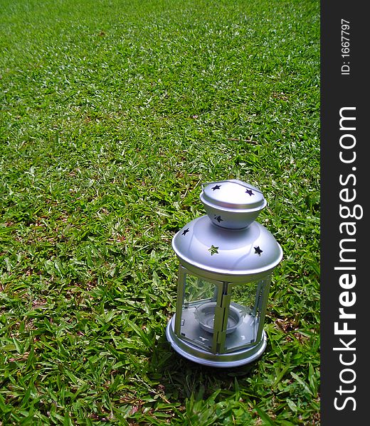 Silver Christmas Lamp On Green Grass Background