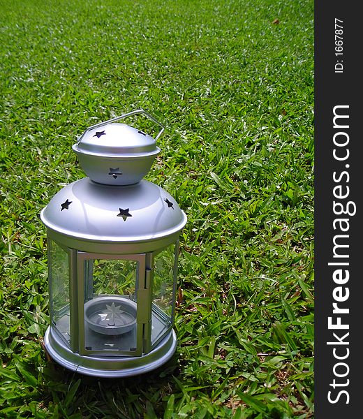 Silver Christmas Lamp On Green Grass Background