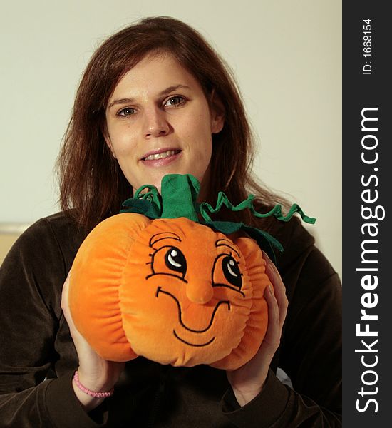 A young beautiful woman with her pumpkin friend. A young beautiful woman with her pumpkin friend.