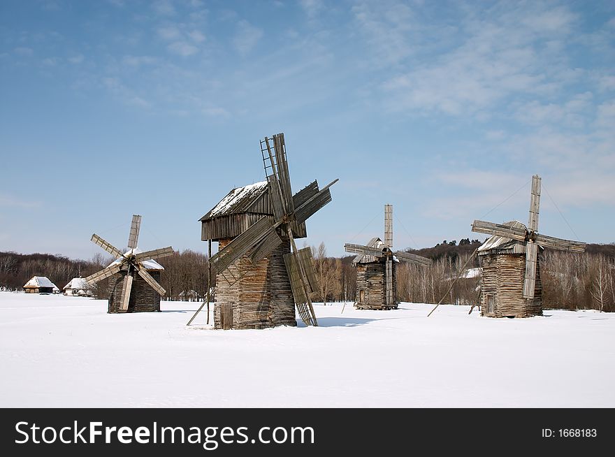 Windmills in the winter countryside scenic under blue sky. Windmills in the winter countryside scenic under blue sky