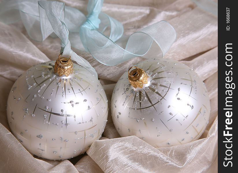 Two christmas spheres on a pink fabric. Two christmas spheres on a pink fabric