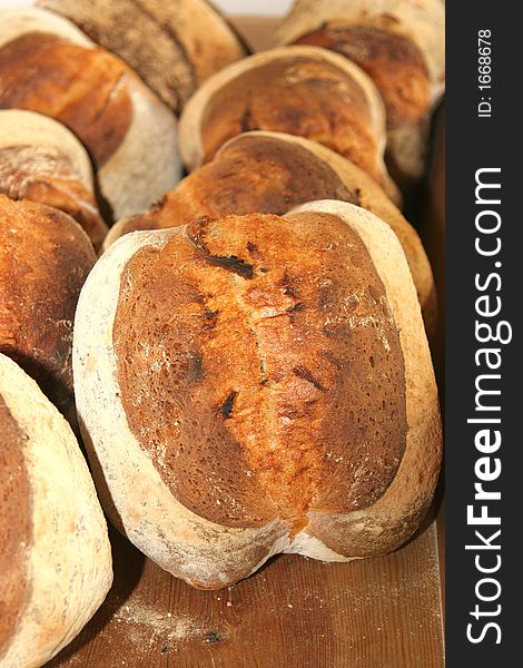 Several loafs of fresh bread standing against each other