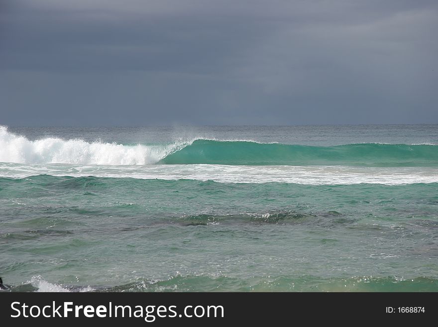 Turquoise wave breaking