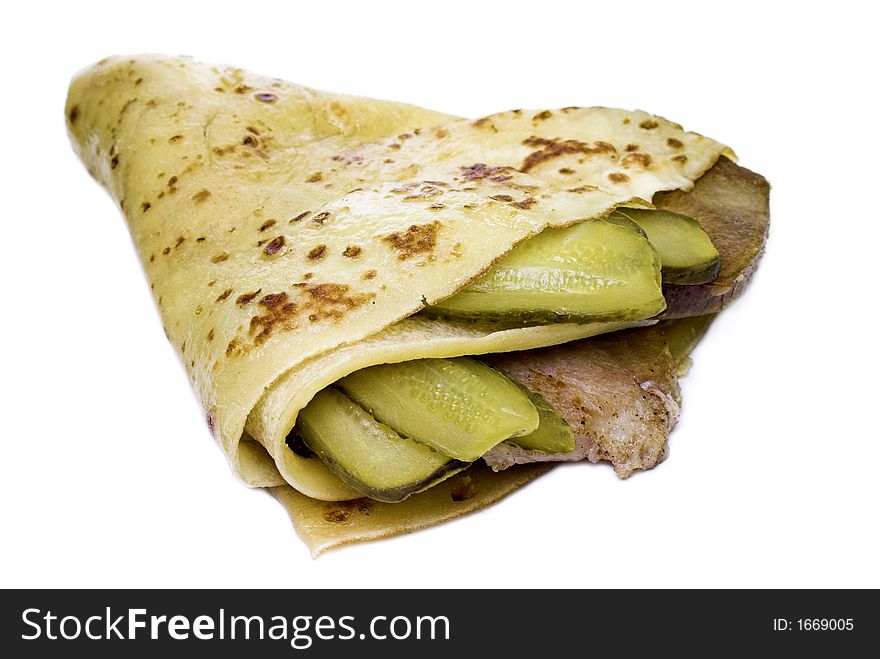 Meat with cucumber enfolded in pancake. Russian snack