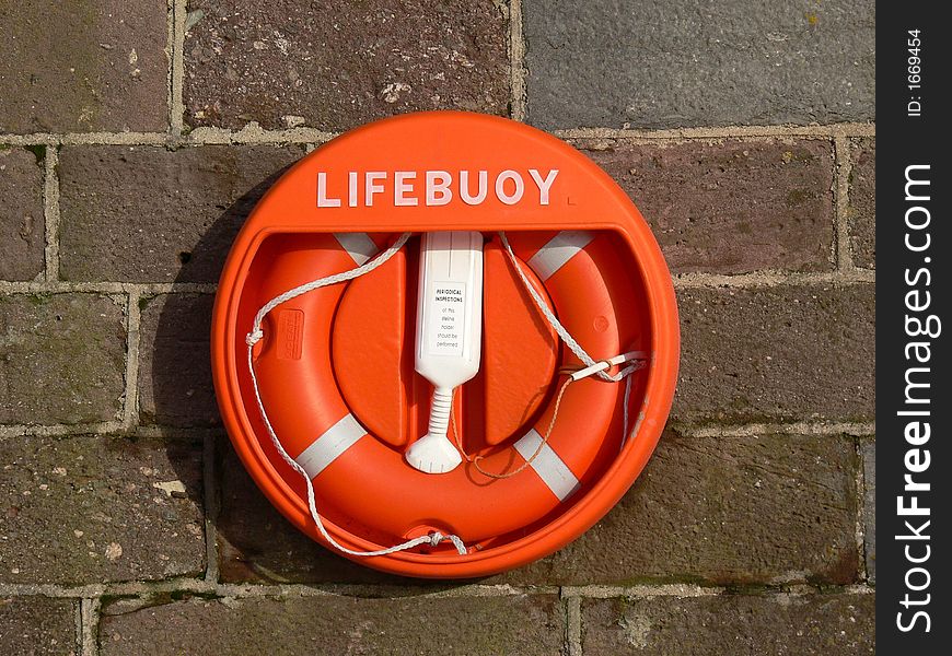 A lifebuoy attached to a harbour wall