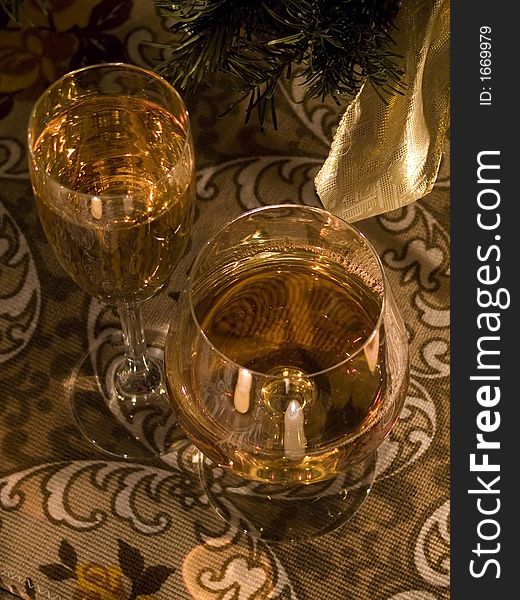 Close look on two glasses with vine in it on the ornamental tea-cloth. Close look on two glasses with vine in it on the ornamental tea-cloth