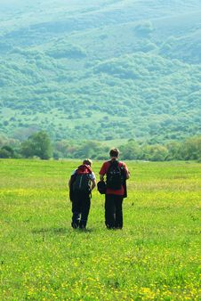 Tourists In Mountain Meadow Royalty Free Stock Photos