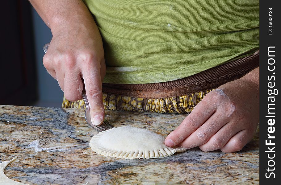 Enhancing raw Pierogi with fork. Enhancing raw Pierogi with fork