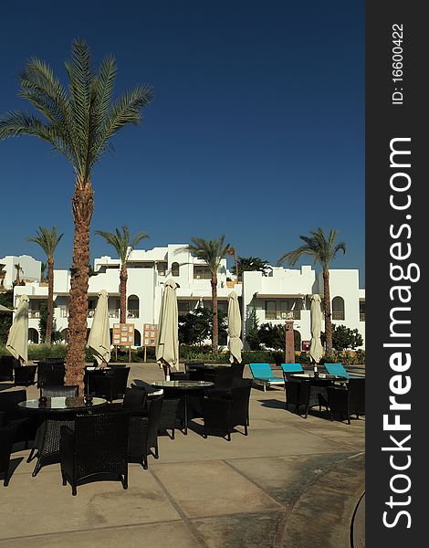 Empty cafe with chairs and tables standing outdoor. Empty cafe with chairs and tables standing outdoor.