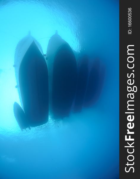 Underwater View Of Dive Boats Moored Together