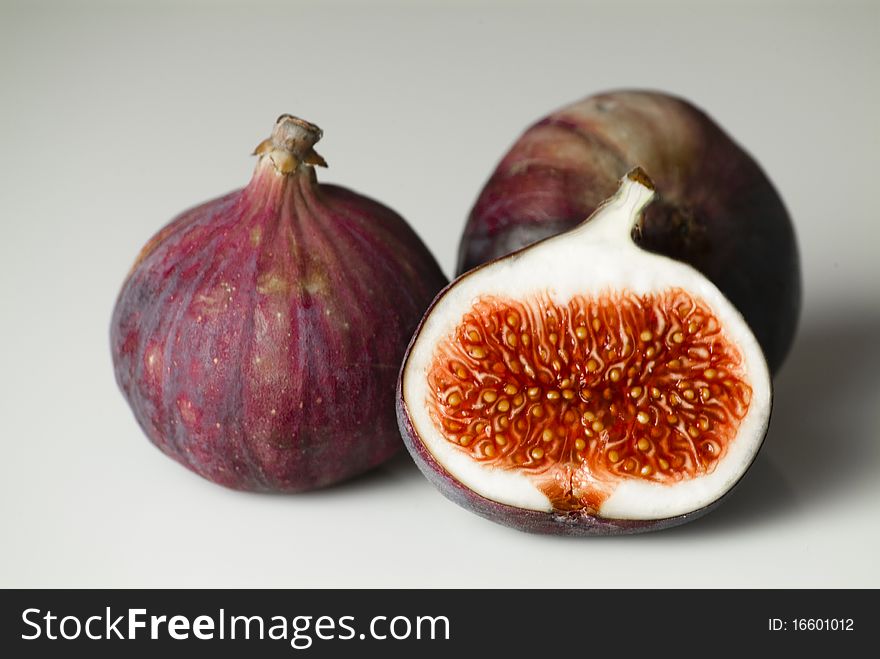 Closeup of three figs on a table