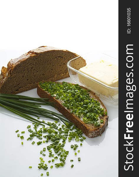 Bread butter and chives on a table