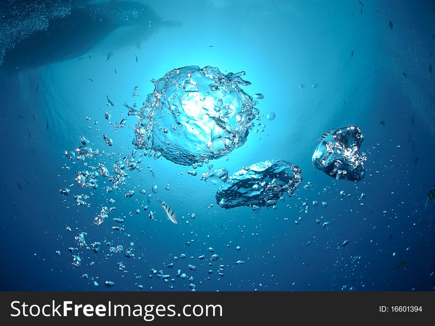 Bubbles in the ocean with dive boat above. Bubbles in the ocean with dive boat above