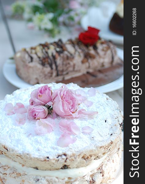 Cakes sit on a table ready to be served to guests. Cakes sit on a table ready to be served to guests