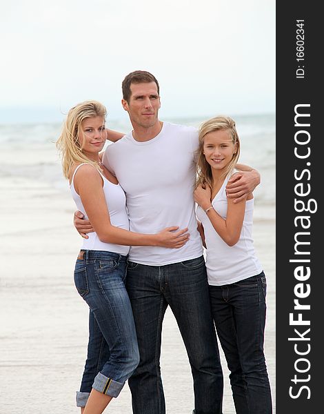 Couple and daughter standing by the sea. Couple and daughter standing by the sea