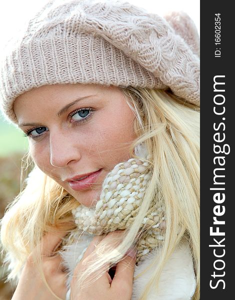 Blond woman wearing wool cap in autumn. Blond woman wearing wool cap in autumn
