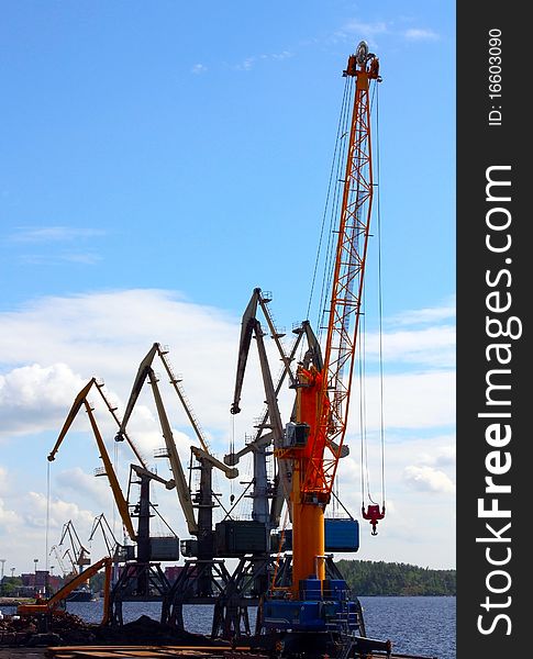 Few port cranes against the bay in Vyborg, Russia
