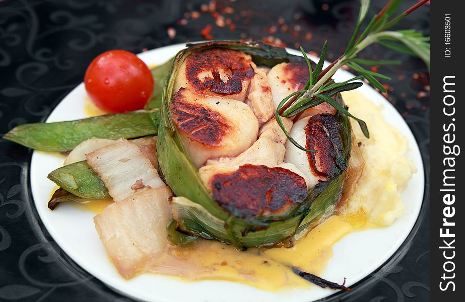 Baked scallops tatin (cooked upside down) held together with leek leaves.