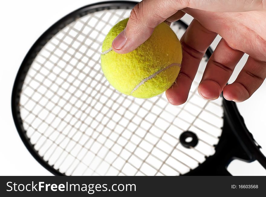 Tennis racket and the hand holding the ball. Isolated on a white background. Tennis racket and the hand holding the ball. Isolated on a white background