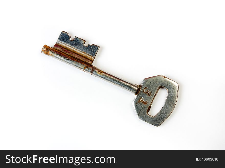 STOCK PHOTO of a rusty key on white background.