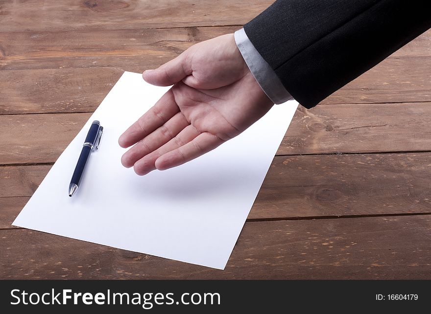 Part of hands signing a contract. Part of hands signing a contract