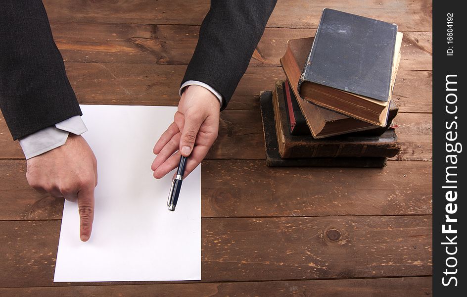 Part of hands signing a contract. Part of hands signing a contract